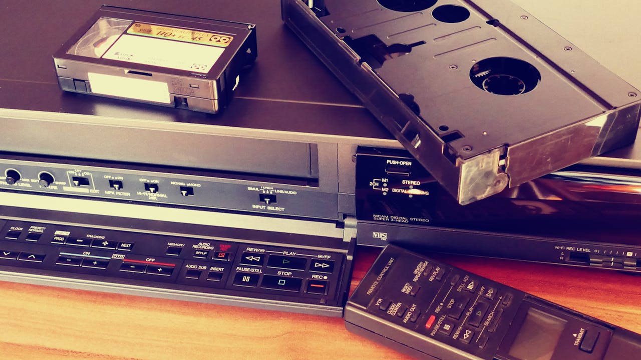 services-01 Vintage VHS player with cassette and remote control, representing classic tech nostalgia.
